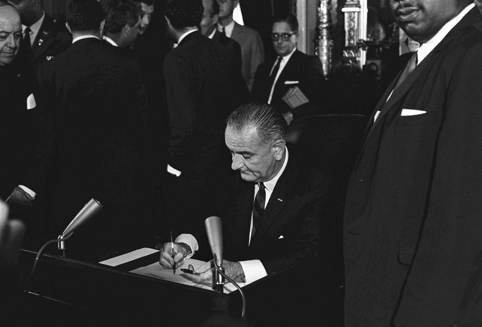 President Lyndon B. Johnson signs the Voting Rights Act.