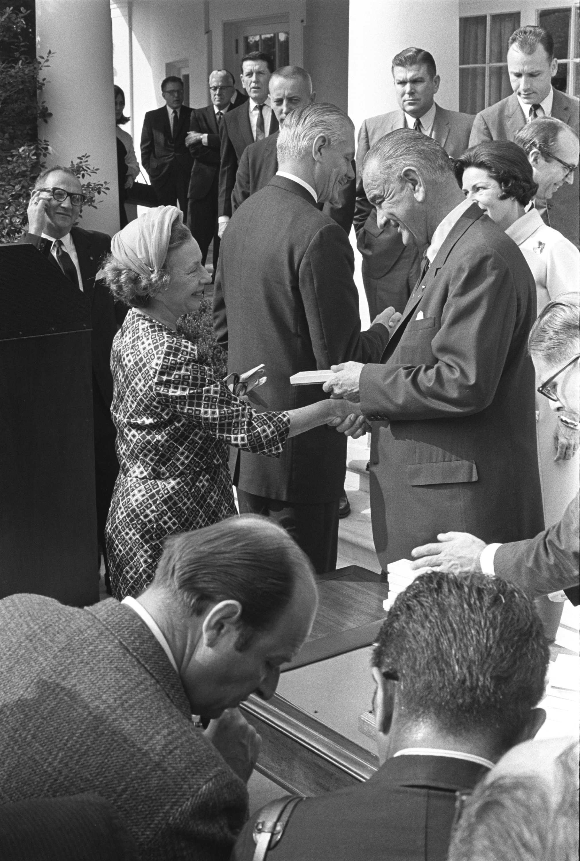 President Lyndon B. Johnson presents American dancer and choreographer Agnes DeMille with a bill signing pen.