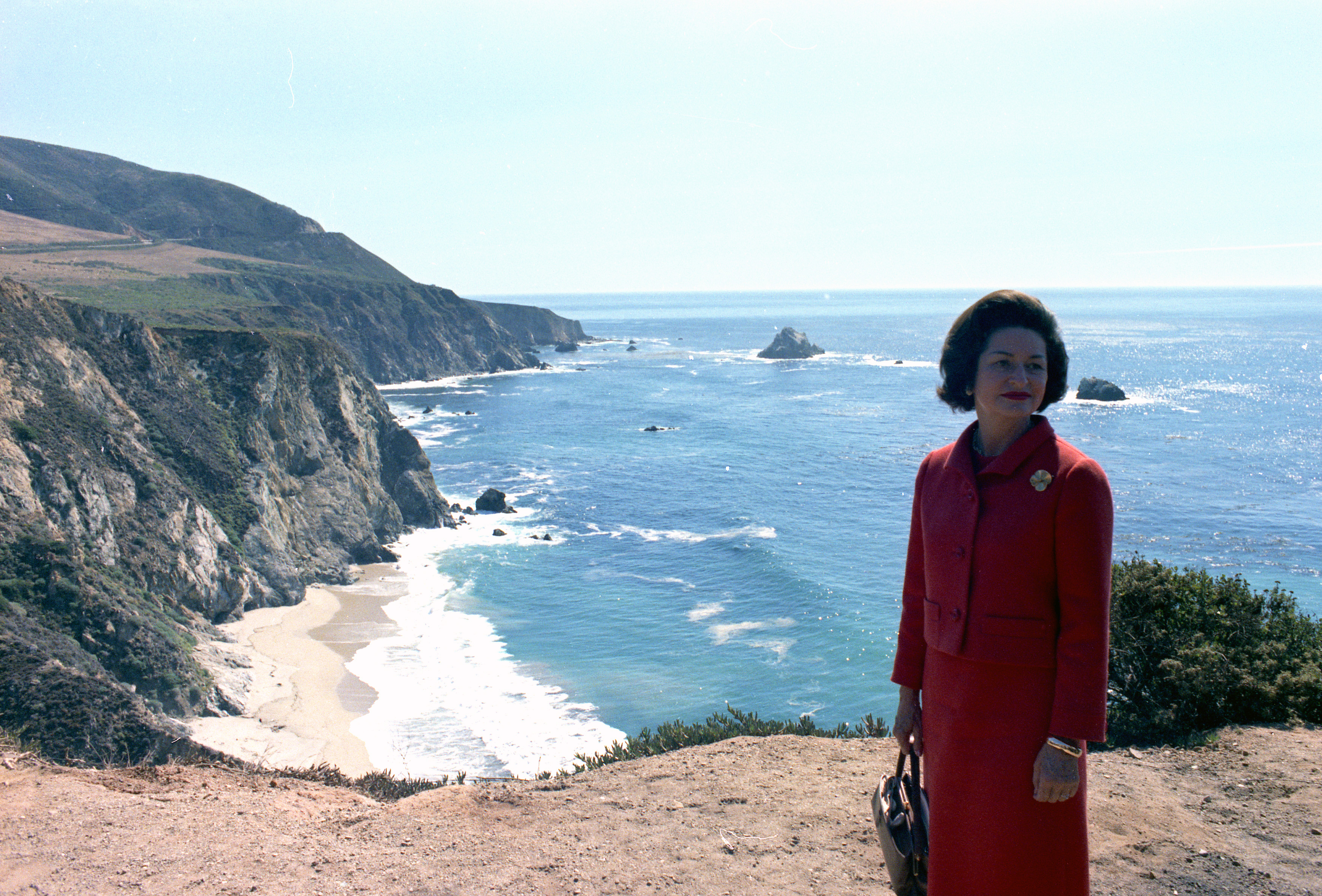 Lady Bird Johnson with the California coast behind her.