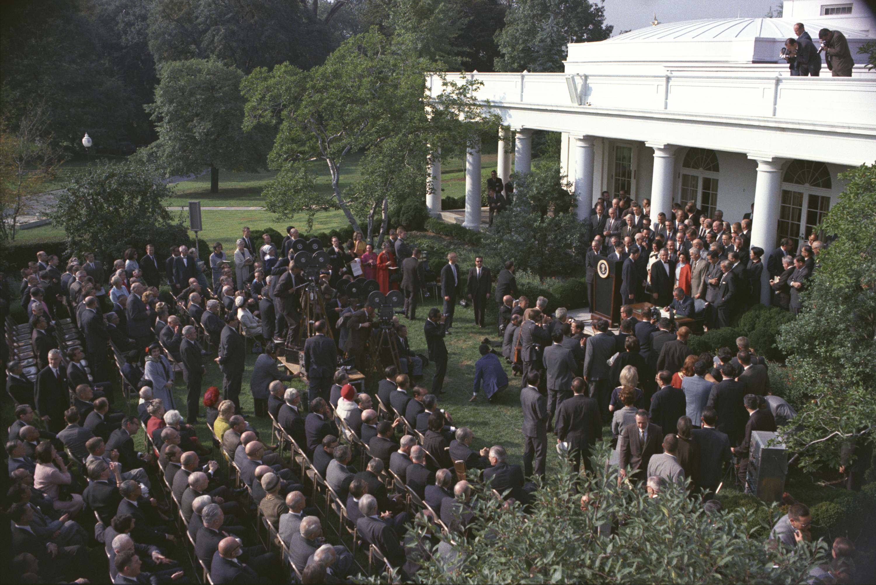 President Lyndon B. Johnson signs the bill.