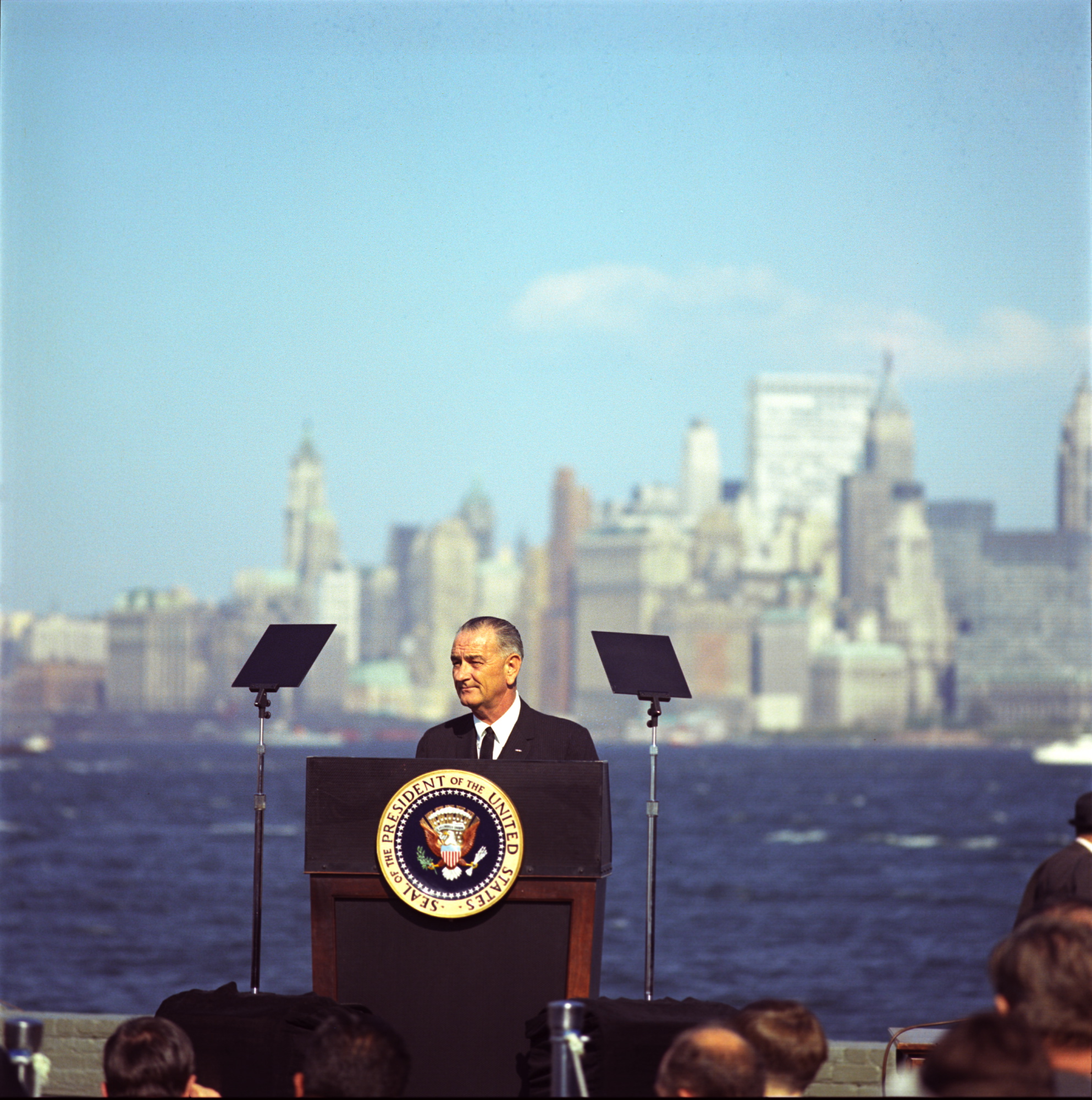 With the New York City skyline in the background, President Lyndon B. Johnson gives his remarks before signing the Immigration and Nationality Act.