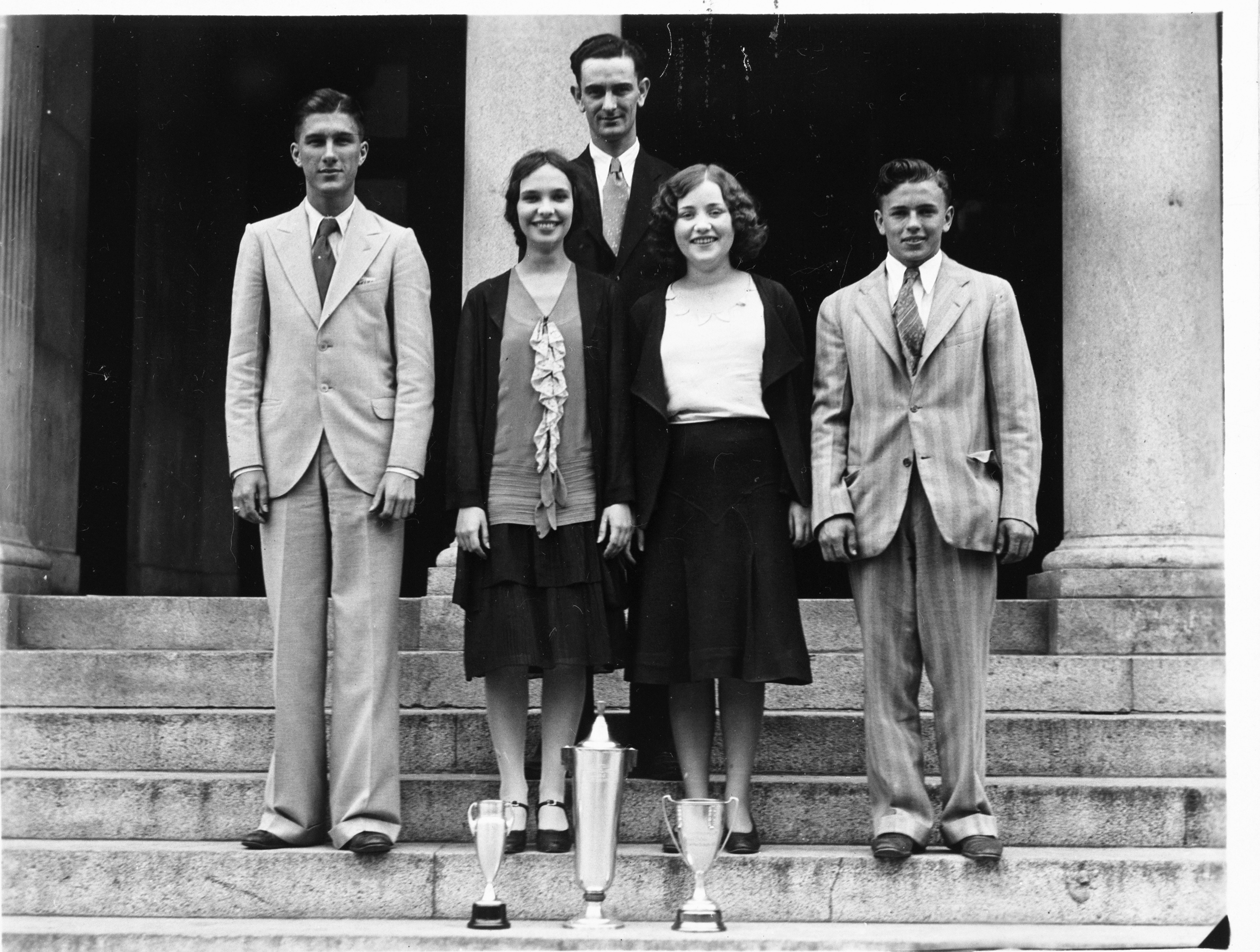 Lyndon B. Johnson, the debate coach at Sam Houston High School at the time, poses with his championship team--Luther Jones, Margaret Epley, Evelyn Lee, and Gene Lattimer.