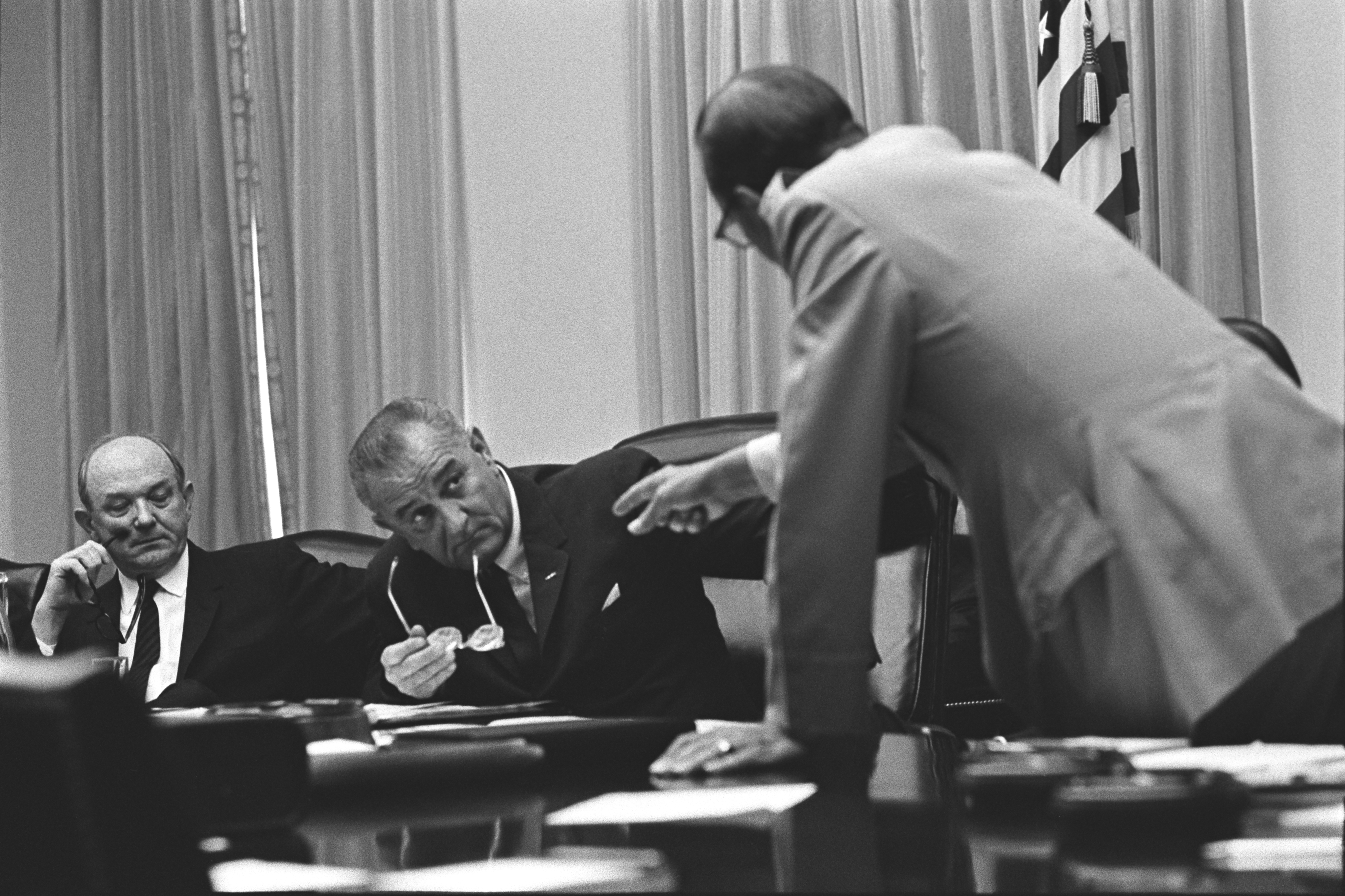 Gen. Earle Wheeler leaning forward, speaking to Pres. Lyndon B. Johnson and gesturing as Sec. Dean Rusk (left) looks on. LBJ Library photo by Yoichi Okamoto #A913-21.