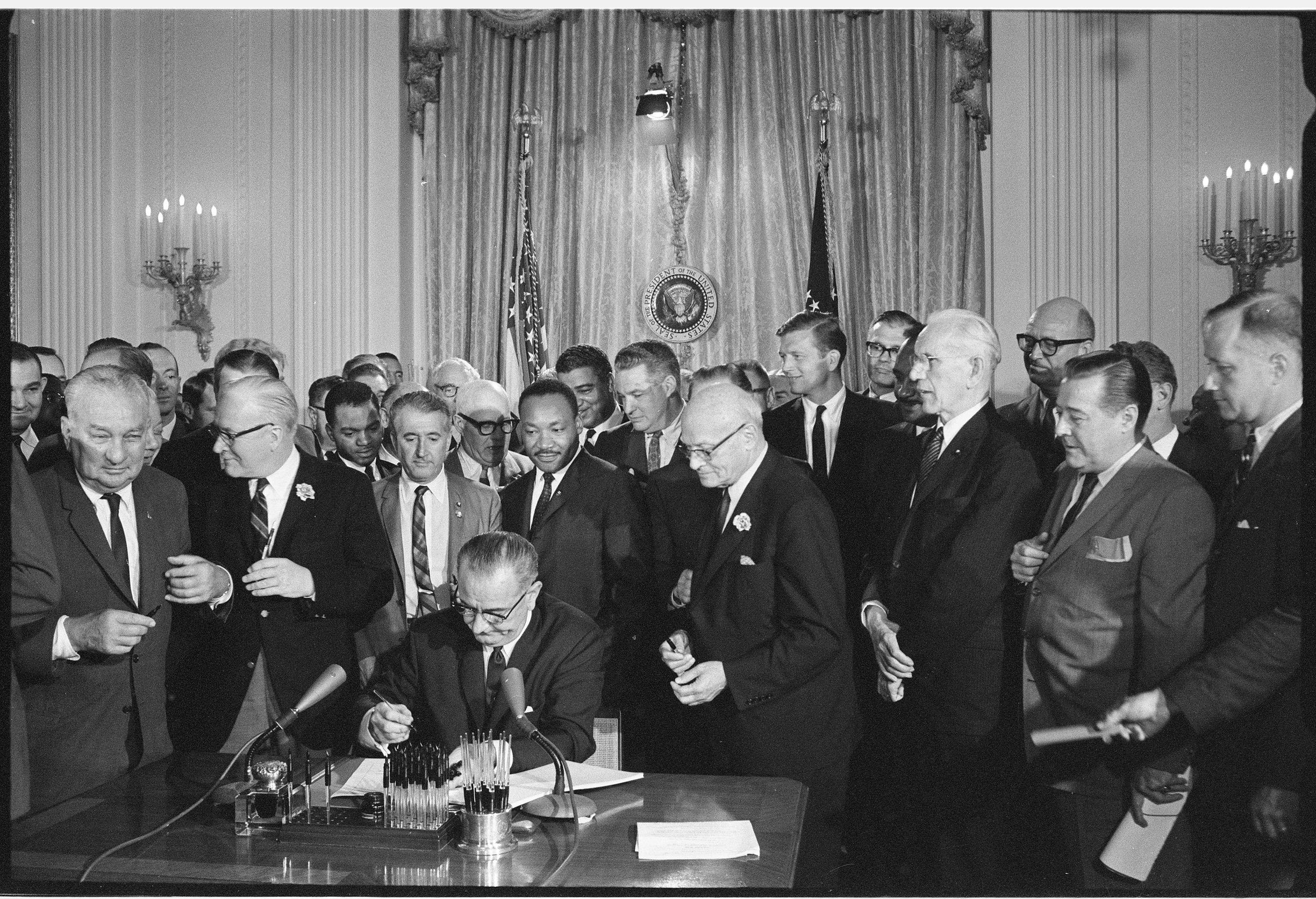 Signing of the Civil Rights Act of 1964. LBJ Library photo by Cecil Stoughton #276-10-WH64.