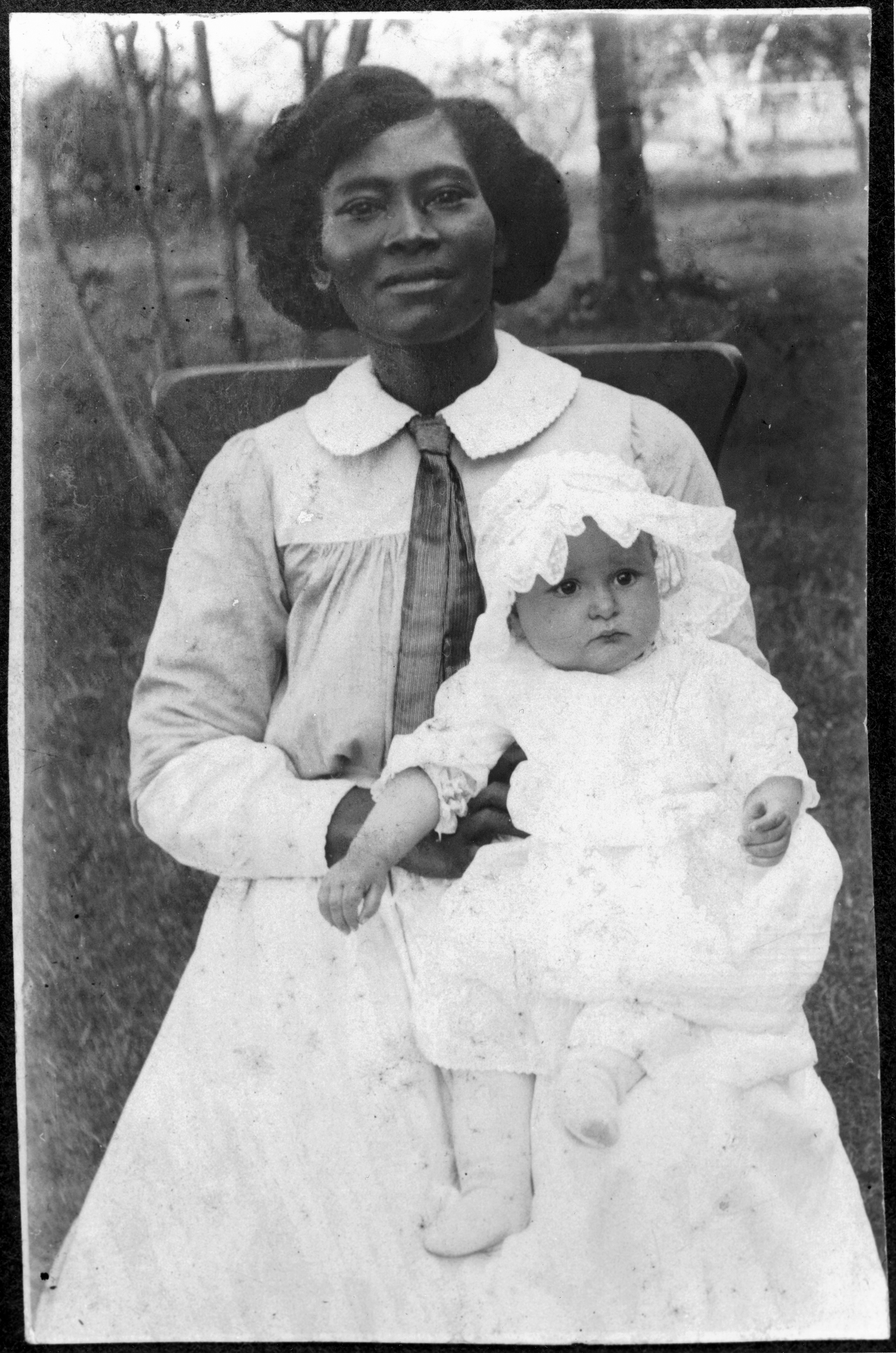 Portrait of Claudia Alta Taylor (age about 6 months) held by her nurse, Alice Tittle