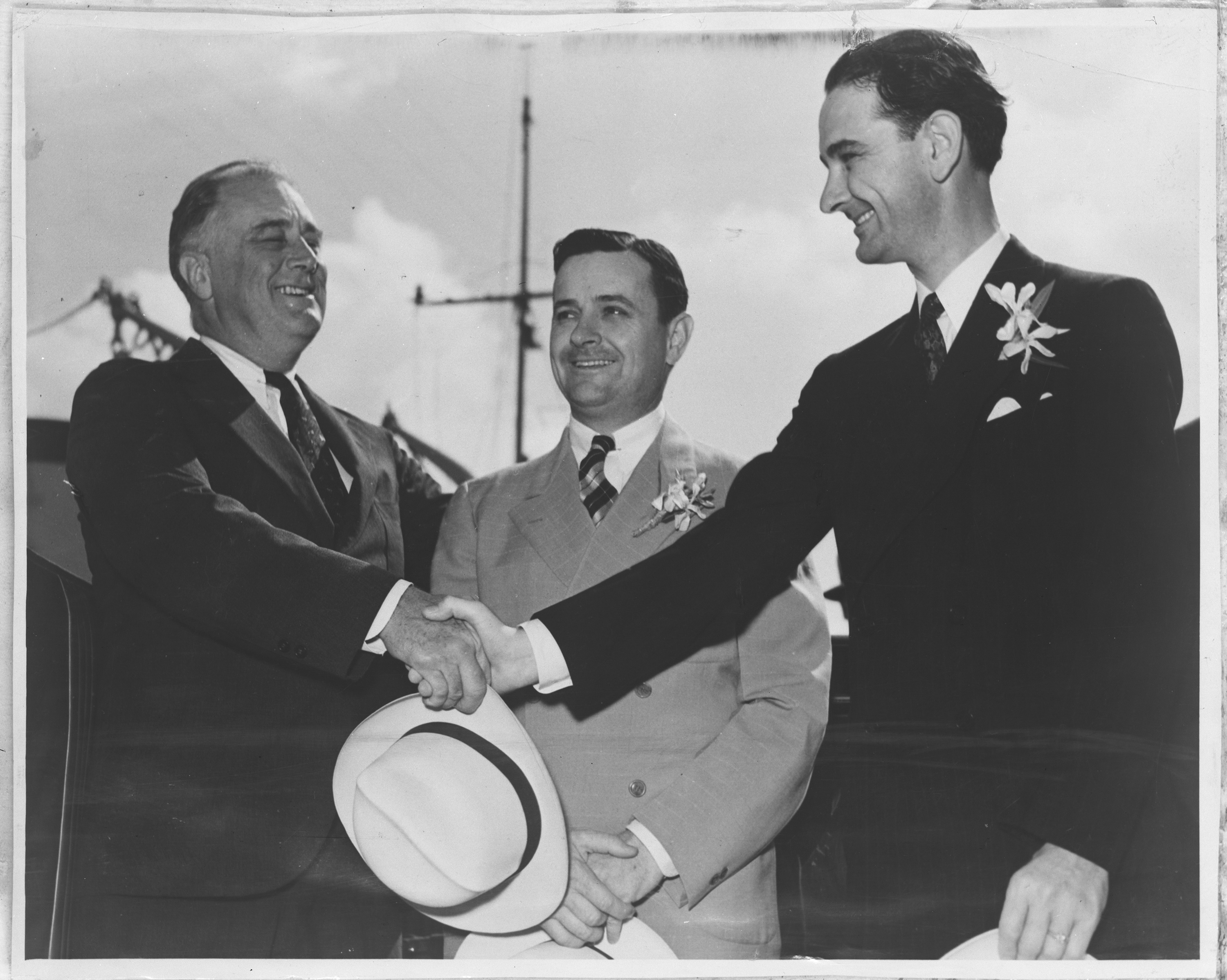 President Franklin D. Roosevelt shakes Congressman Johnson's hand while Texas Governor James Allred stands between them.