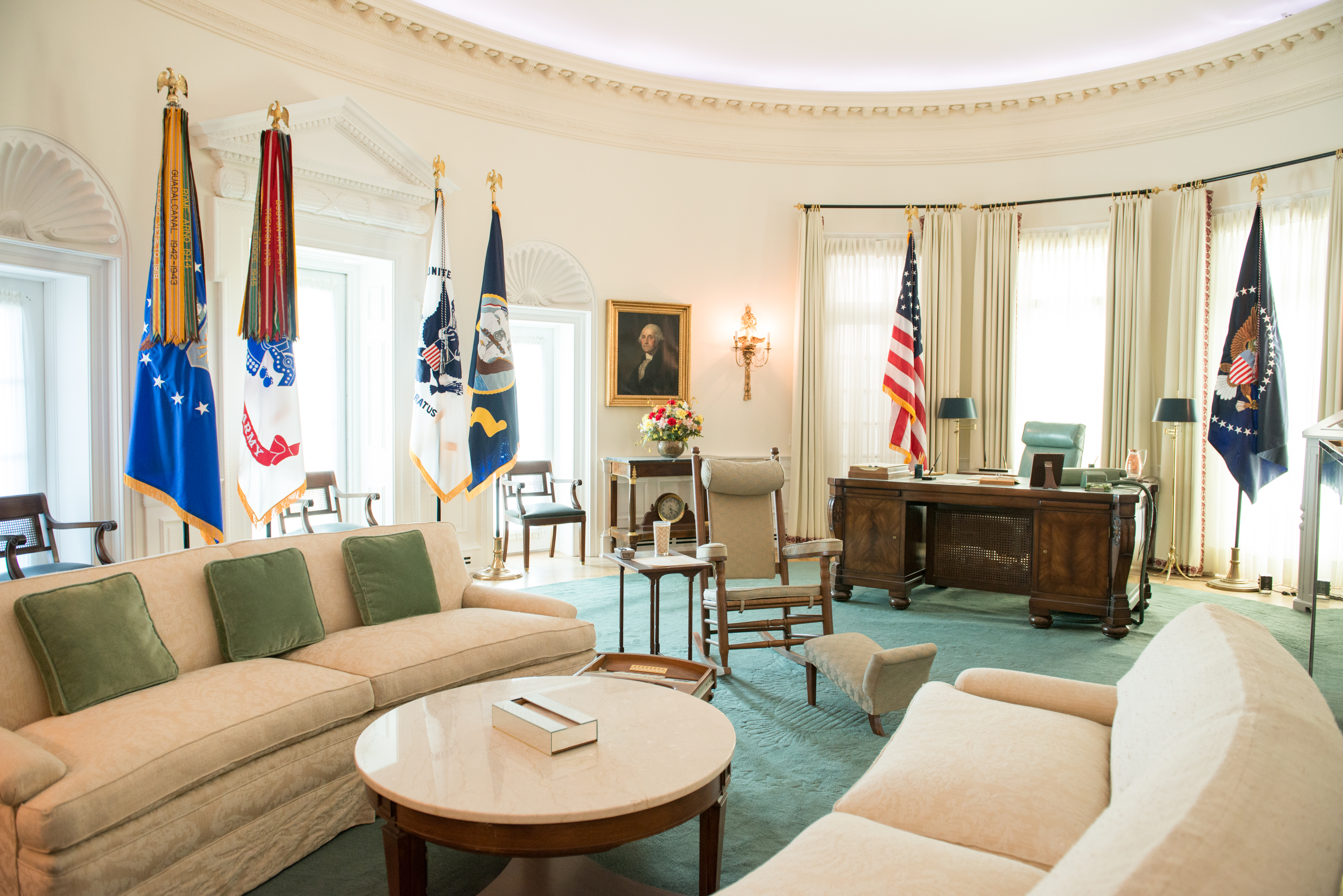 The Oval Office replica at the LBJ Presidential Library. This famous room from the West Wing of the White House has been reproduced in our library at a 7/8th scale. The Oval Office looks exactly as it did during LBJ's White House years, including the desk he used beginning in his Senate days through the White House years, rocking chair, telephone system, and the teletype machines and three televisions that kept him up to date on the news.