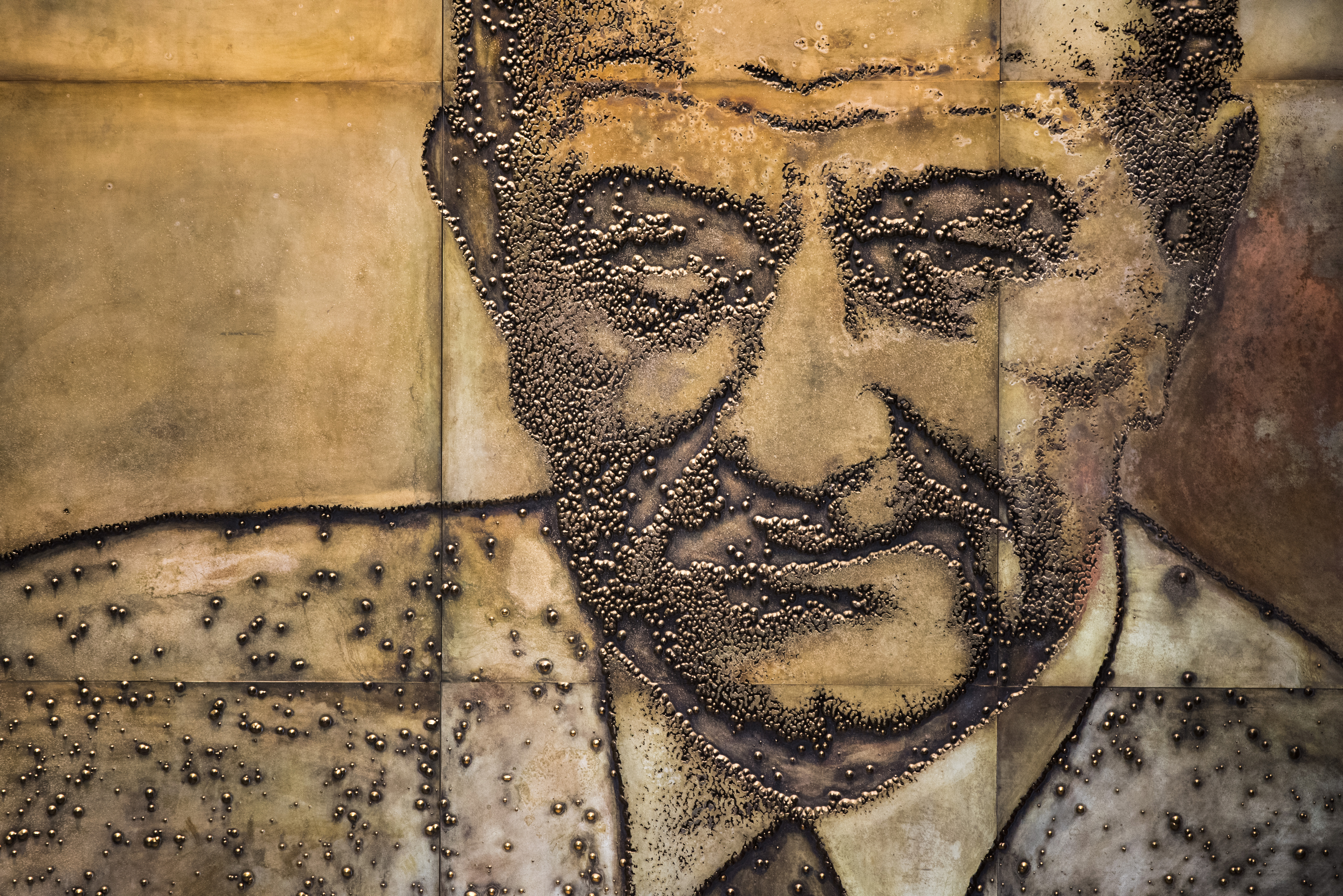 A section of a 50-foot-long mural that shows Lyndon Johnson at various stages of his career.