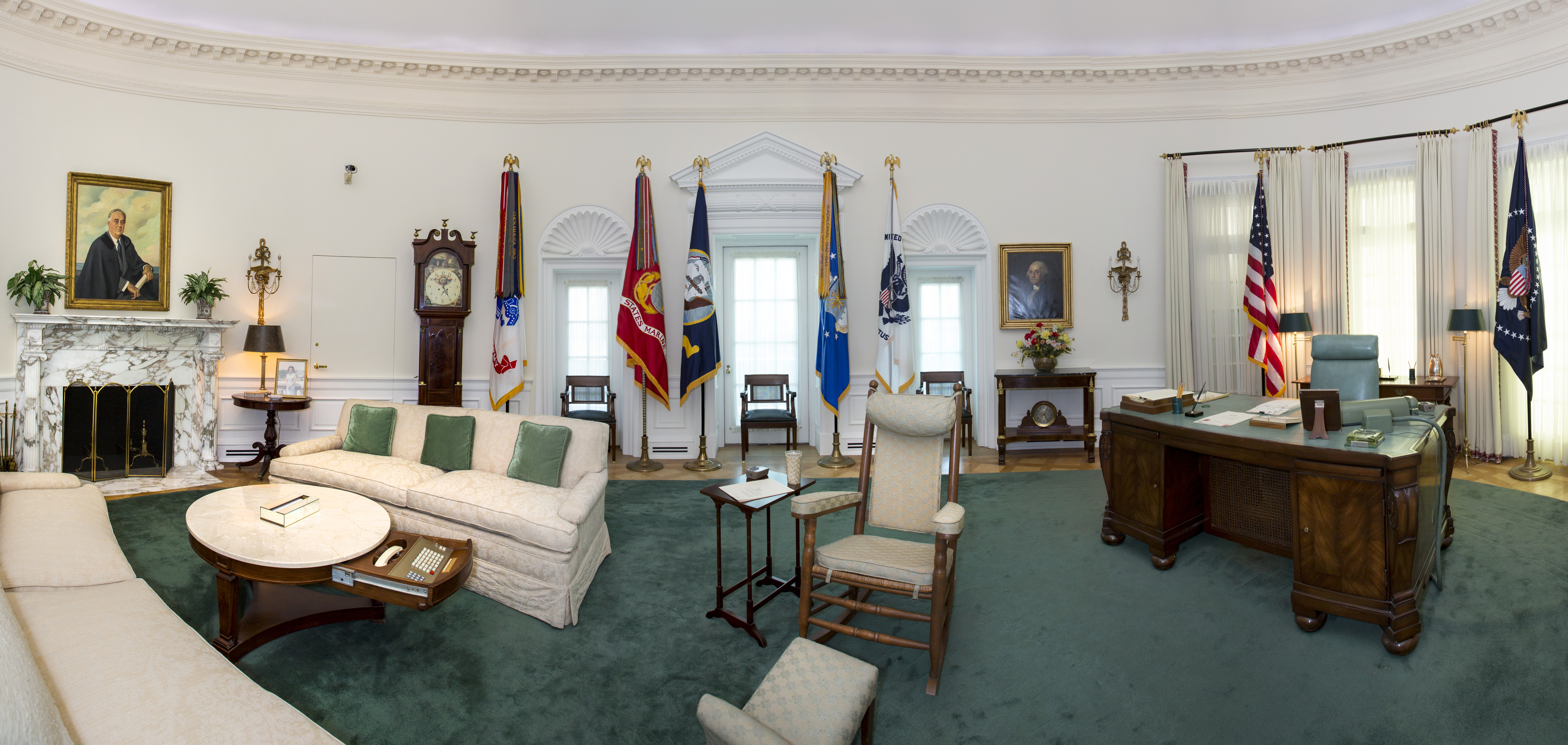 The Oval Office replica at the LBJ Presidential Library in a composite photo. This famous room from the West Wing of the White House has been reproduced in our library at a 7/8th scale. The Oval Office looks exactly as it did during LBJ's White House years, including the desk he used beginning in his Senate days through the White House years, rocking chair, telephone system, and the teletype machines and three televisions that kept him up to date on the news. Photo stitched together in Photoshop from severa