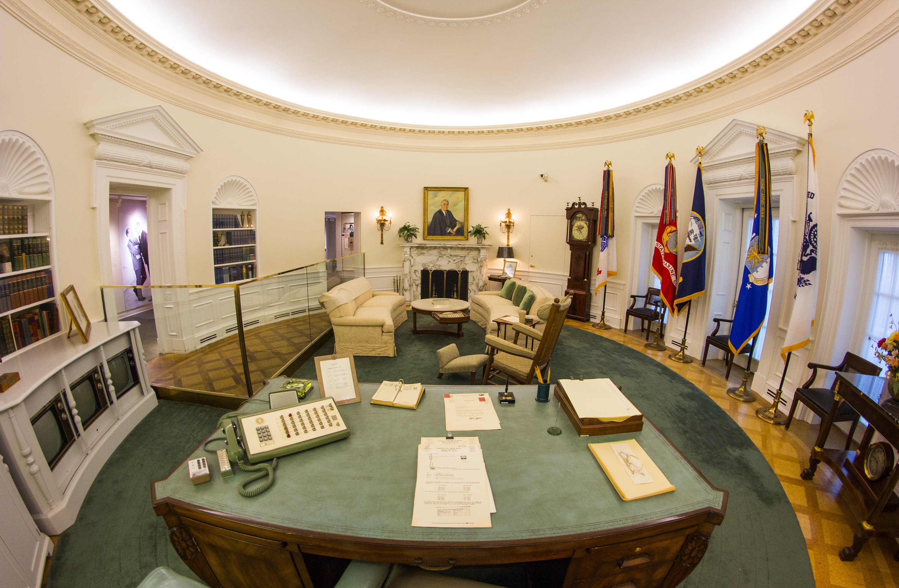 The Oval Office replica at the LBJ Presidential Library. This famous room from the West Wing of the White House has been reproduced in our library at a 7/8th scale. The Oval Office looks exactly as it did during LBJ's White House years, including the desk he used beginning in his Senate days through the White House years, rocking chair, telephone system, clocks, and the teletype machines and three televisions that kept him up to date on the news.
