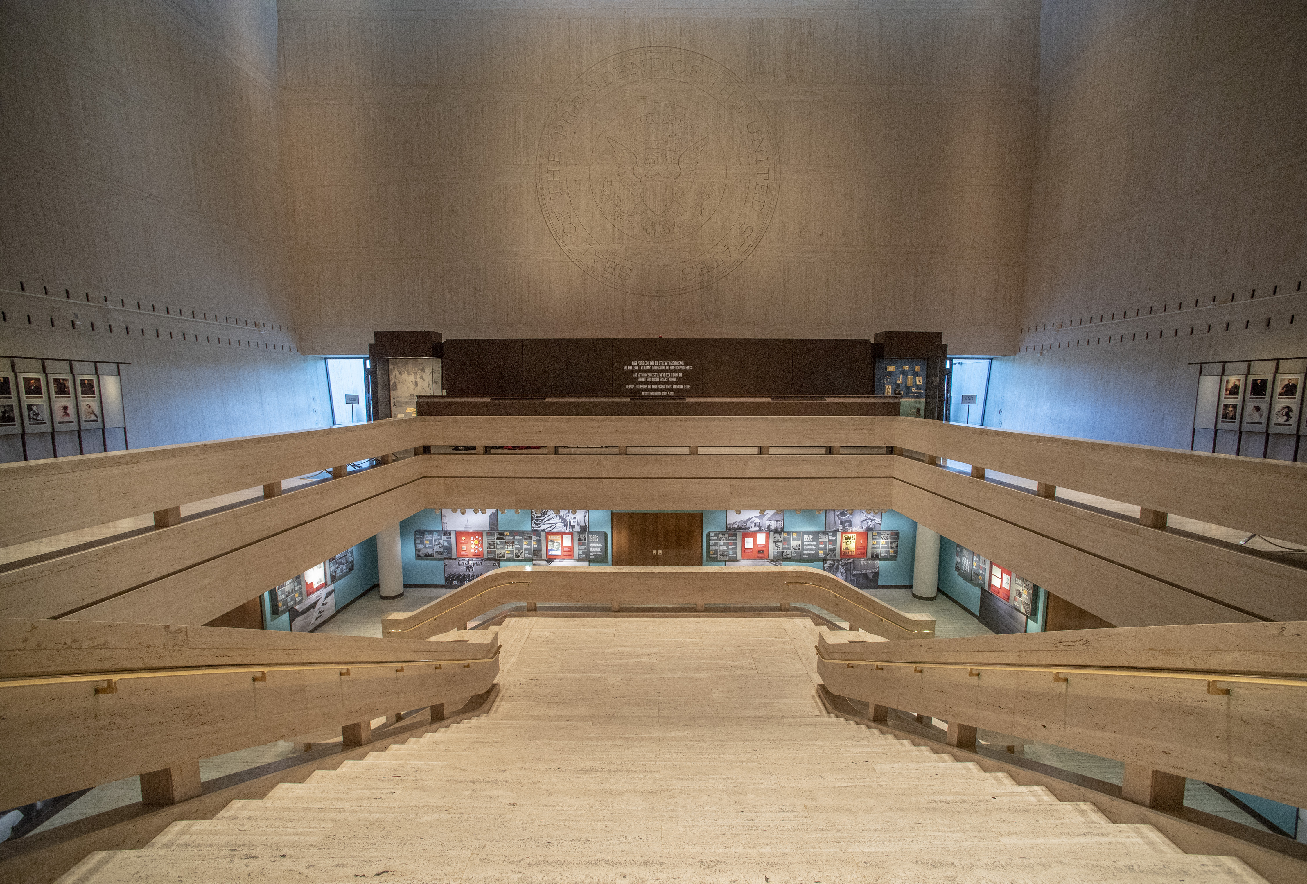 The Great Hall in the LBJ Presidential Library with the Seal of the President of the United States etched in the wall.