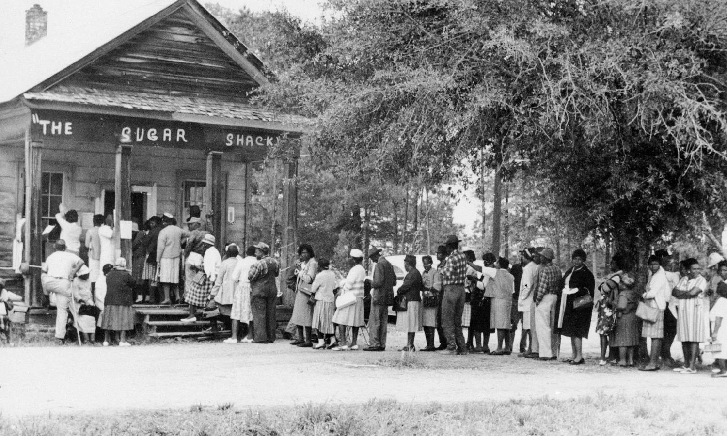 Voters wait in line at a rural polling place in Peachtree, Alabama. May 3, 1966. Credit to Records of the United States Information Agency.