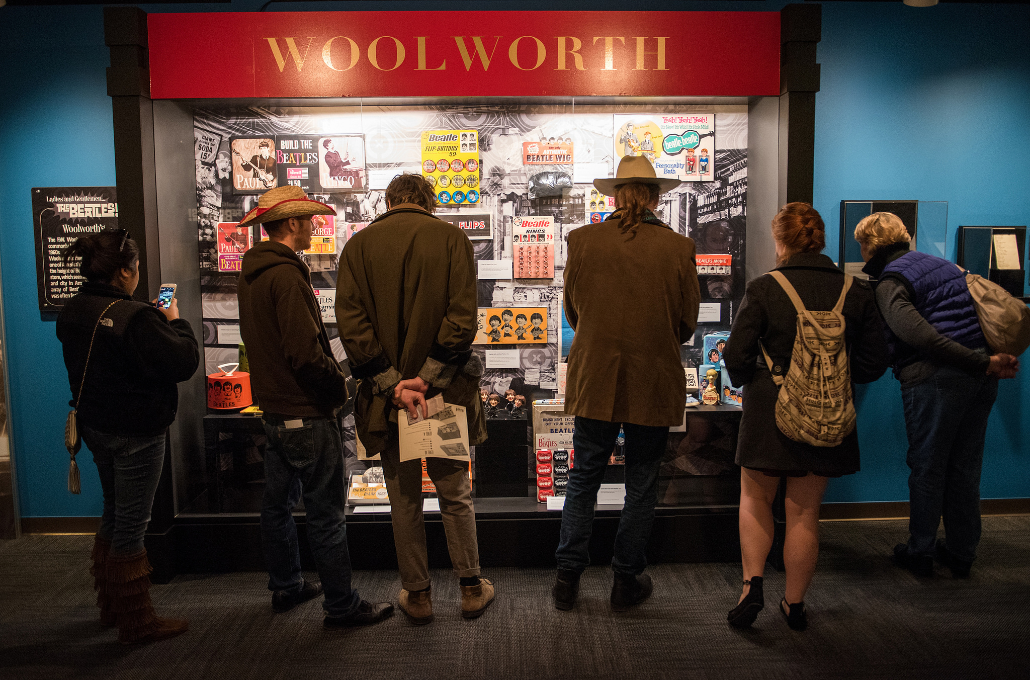 Visitors examine artifacts in the "Ladies and Gentlemen…The Beatles!" exhibition at the LBJ Library.