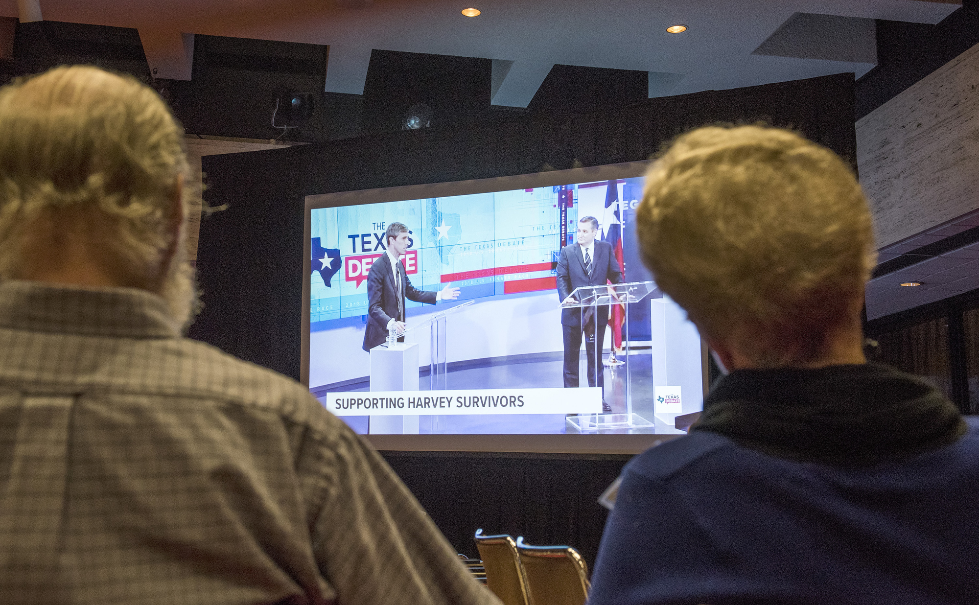 Two participants watch the debate after the panel concluded.
