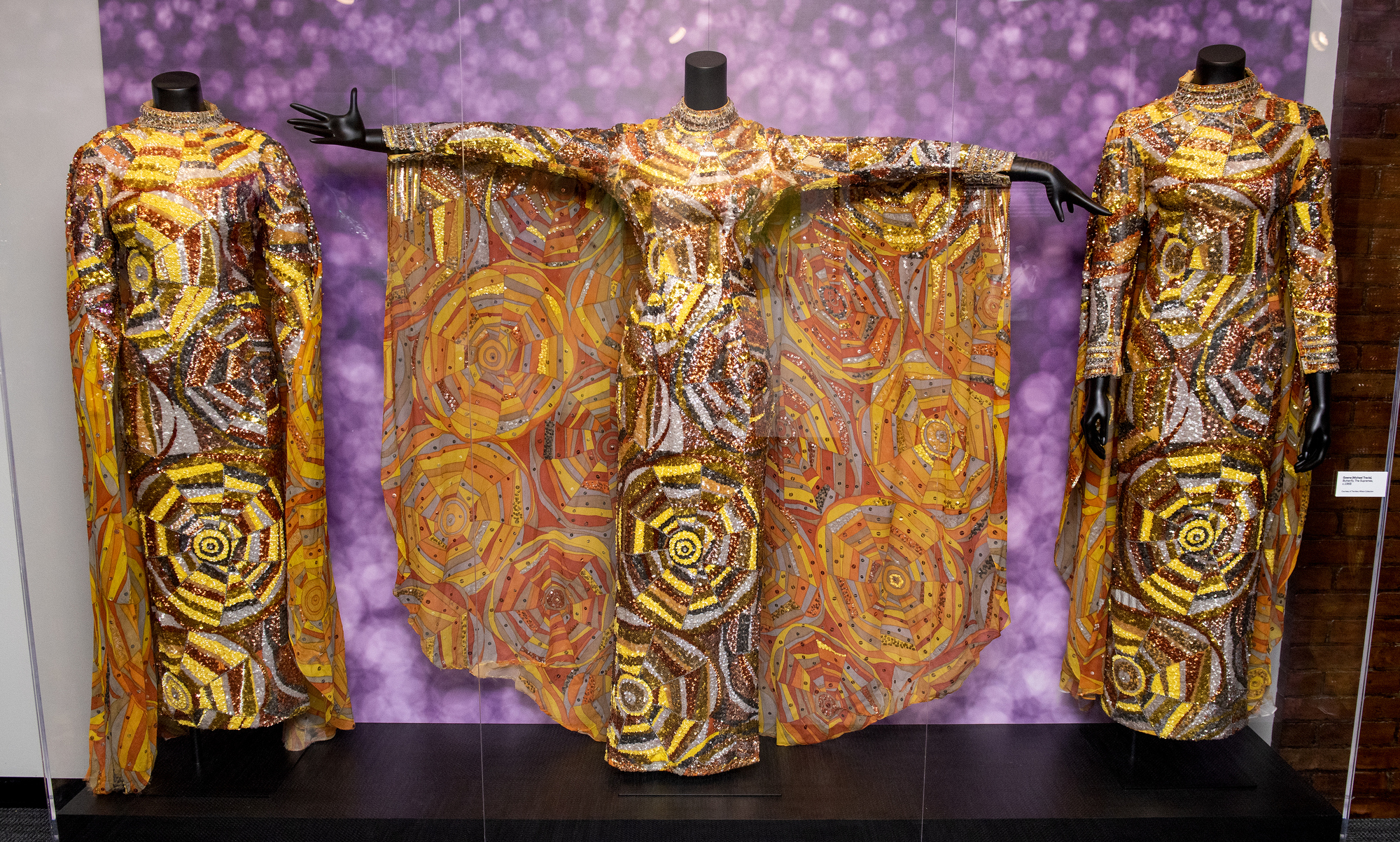 A view of three gold costumes worn by The Supremes that are on display in the "Motown: The Sound of Young America" exhibition.