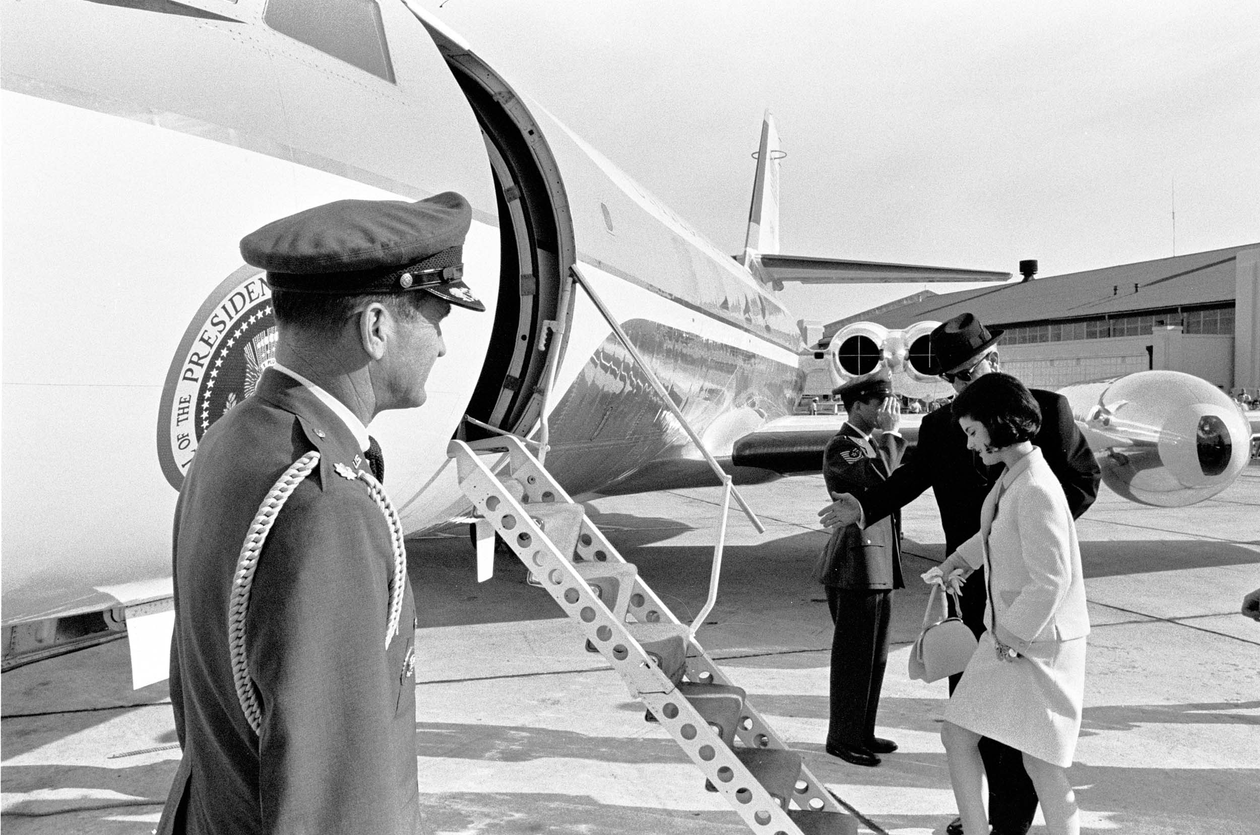 President Lyndon B. Johnson’s daughter, Luci Baines Johnson, boards plane as Col. James Cross looks on.