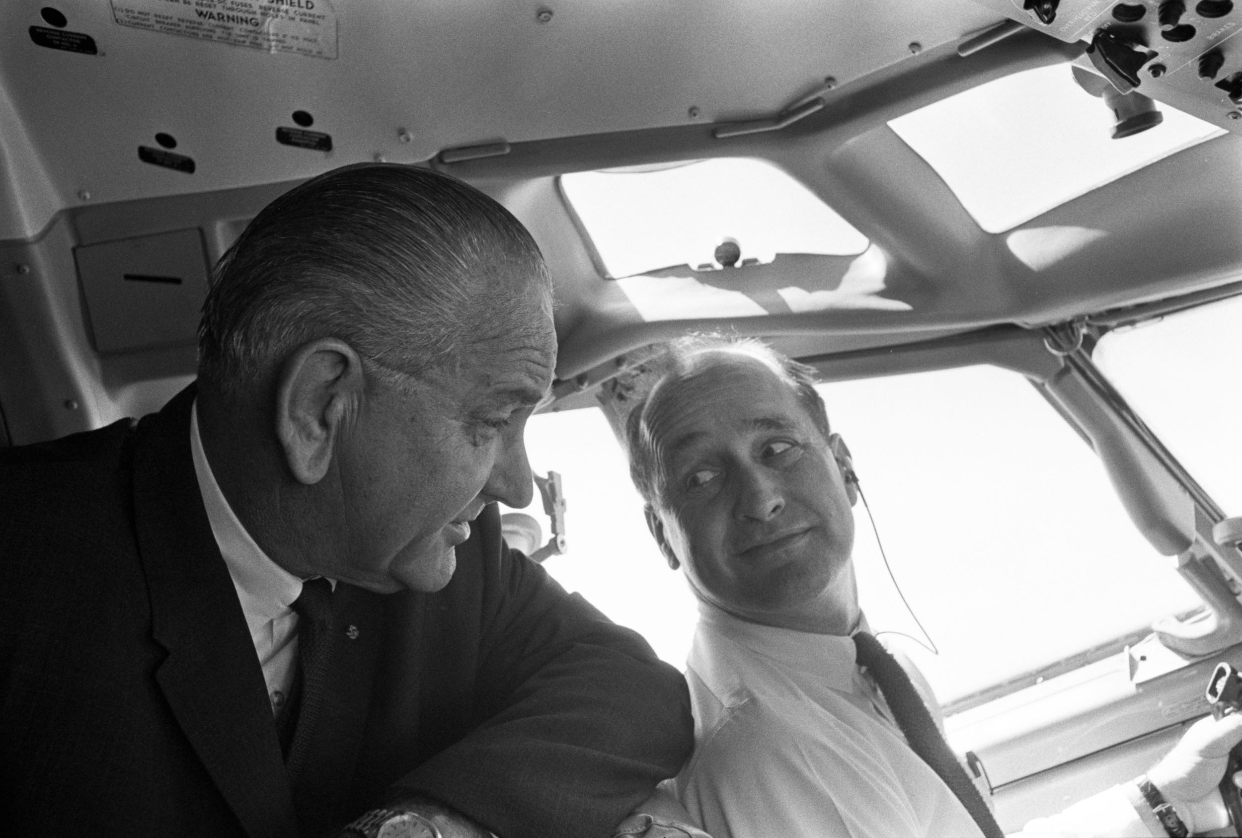 President Lyndon B. Johnson and Col. James Cross in the Air Force One cockpit en route to Washington, D.C. after a trip to Germany.