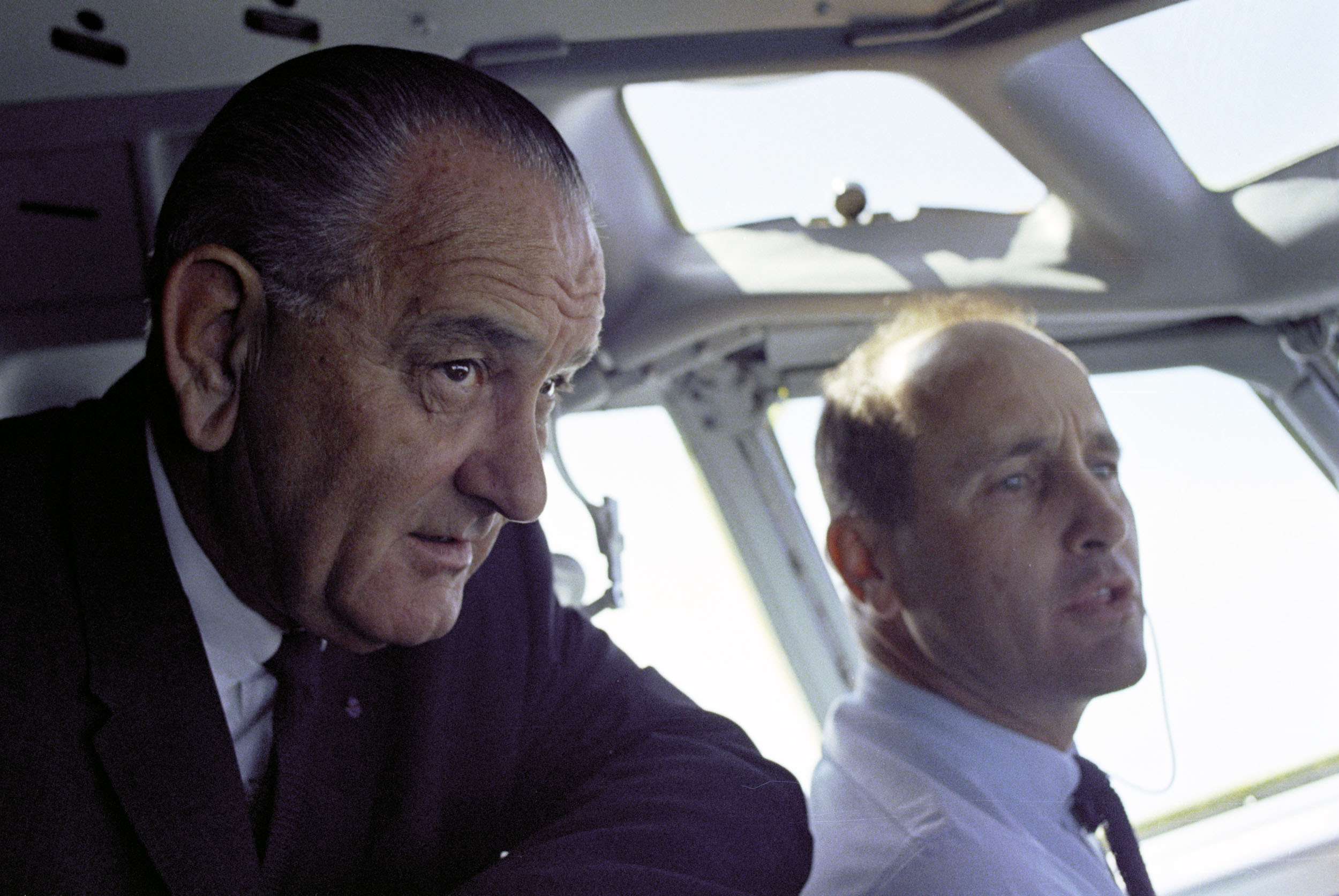 President Lyndon B. Johnson and Col. James Cross in the Air Force One cockpit en route to Washington, D.C. after a trip to Germany.
