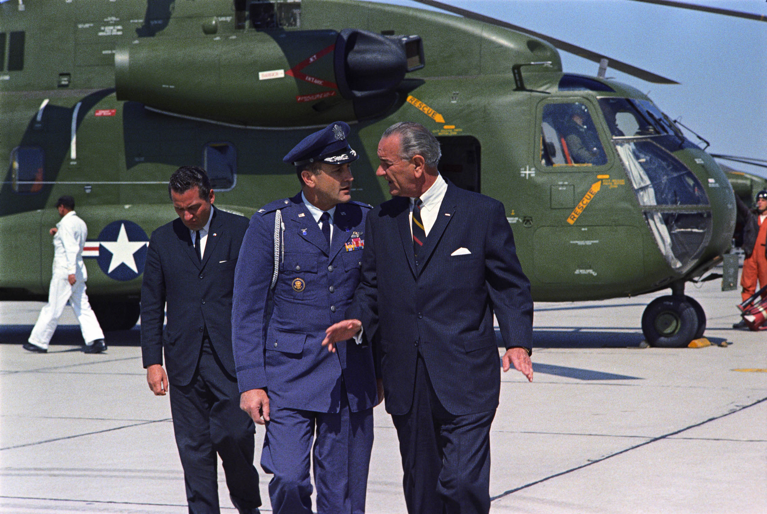 Col. James Cross and President Lyndon B. Johnson speak on the airport tarmac at the March Air Force Base in California.