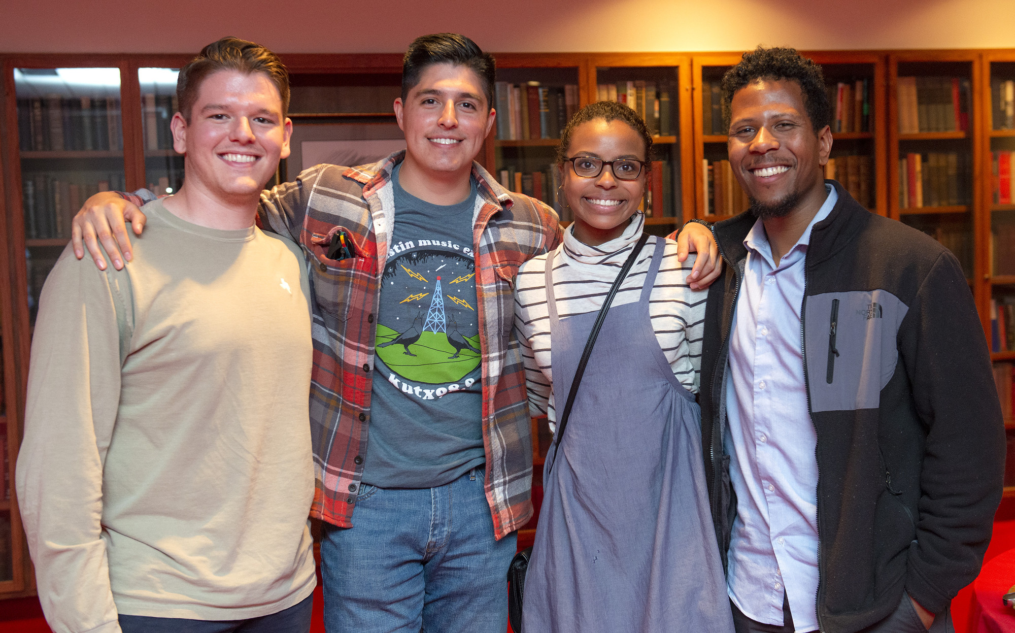 Four attendees pose together at a reception following a Future Forum program at the LBJ Library.