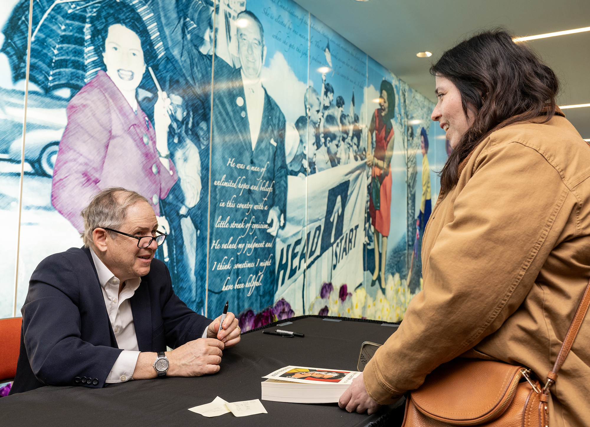 Jonathan Alter signs a book for Jennifer Perales.