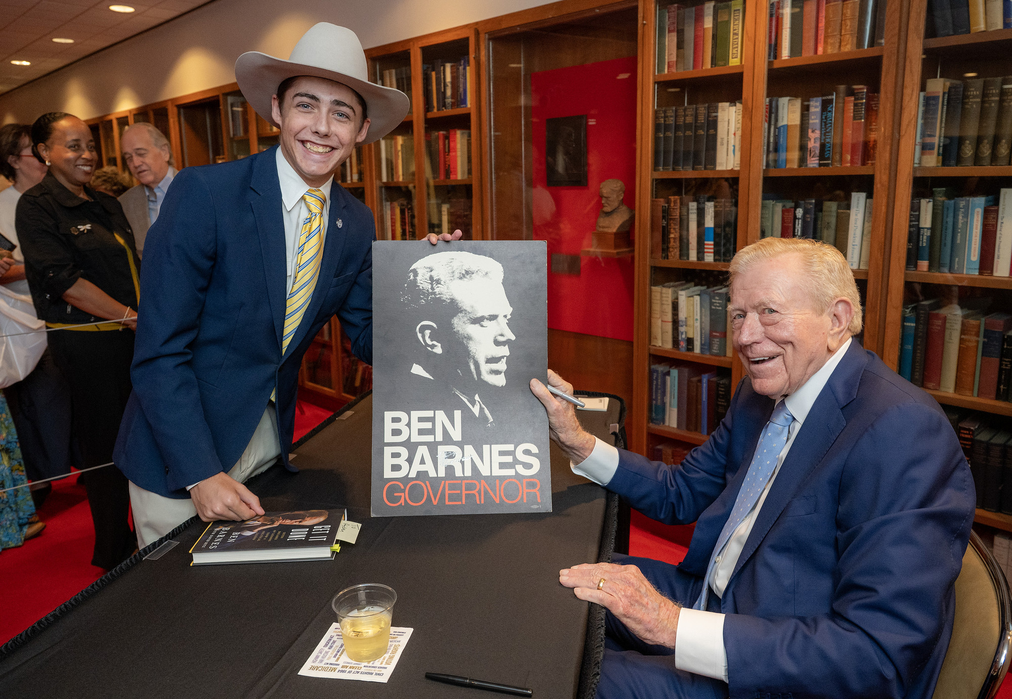 (L-R) Aiden Hunter has his poster signed by Ben Barnes.