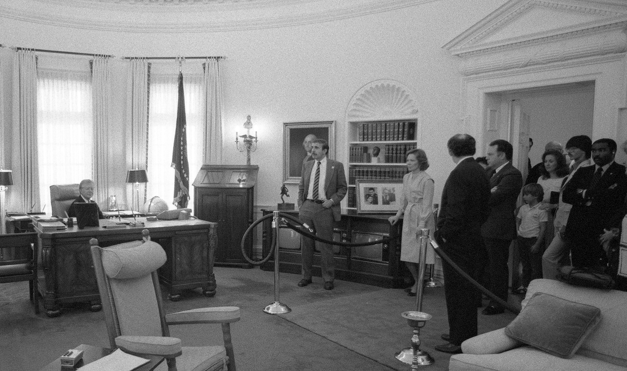 President Jimmy Carter sits in LBJ's chair in the Oval Office exhibition at the LBJ Library.