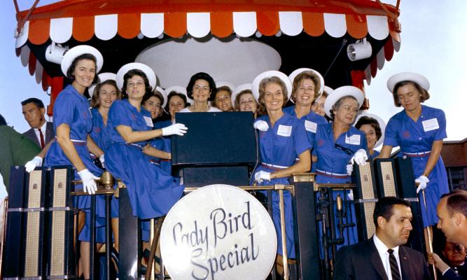 Lady Bird Johnson posing with group of women aboard the Lady Bird Special. LBJ Library photo by Unknown #33317.