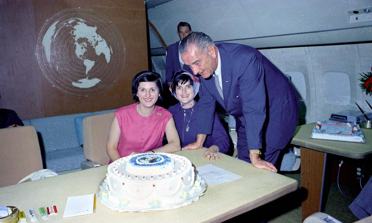 President Lyndon B. Johnson with his birthday cake and daughters Lynda Johnson (left) and Luci Johnson (right). LBJ Library photo by Donald Stoderl #C405-9a.